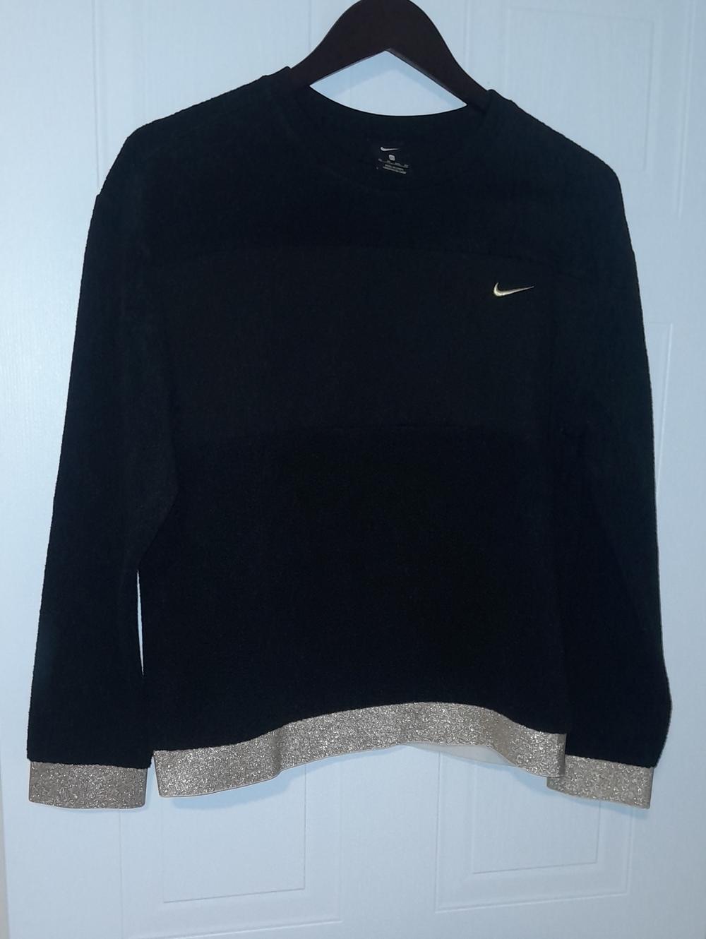 Nike Women's Black Crewneck Sweater with Gold Hem